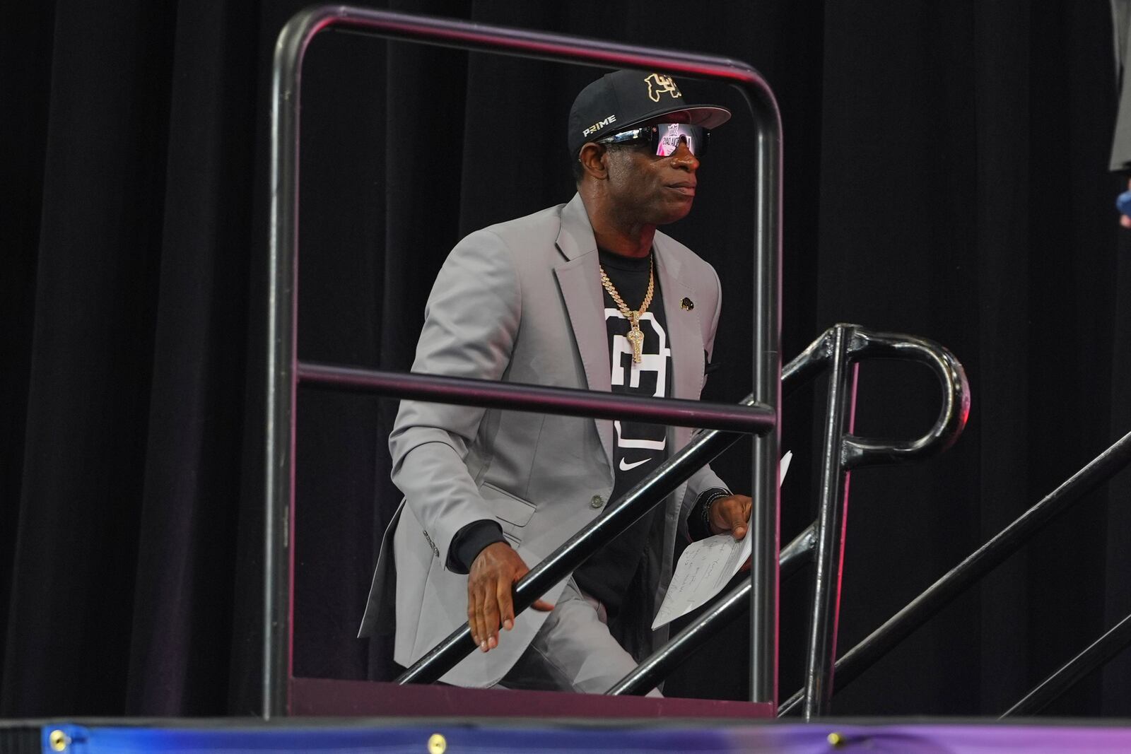 Colorado head coach Deion Sanders walks on stage to speak during the Big 12 NCAA college football media day in Frisco, Texas, Wednesday, July 9, 2025. (AP Photo/LM Otero)