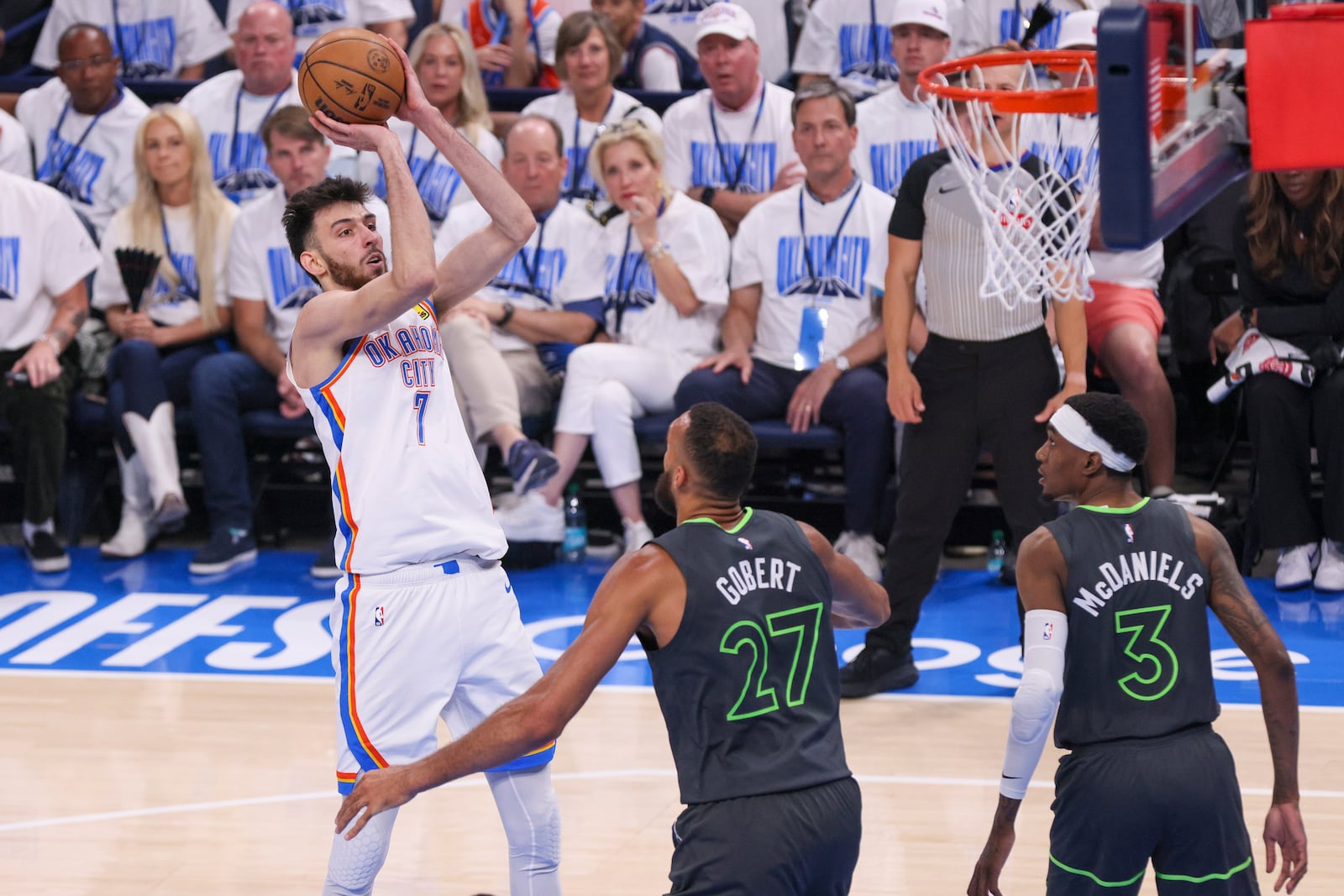 Oklahoma City Thunder forward Chet Holmgren (7) shoots in front of Minnesota Timberwolves center Rudy Gobert (27) and forward Jaden McDaniels (3) during the first half of Game 1 of an NBA basketball Western Conference Finals playoff series Tuesday, May 20, 2025, in Oklahoma City. (AP Photo/Nate Billings)