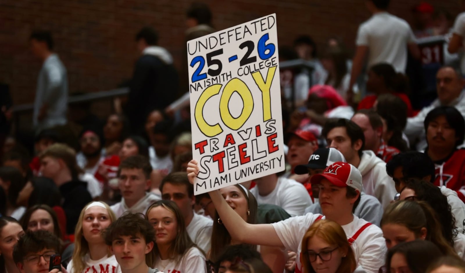 A fan holds up a sign praising Miami coach Travis Steele during a game against Ohio on Friday, Feb. 13, 2026, at Millett Hall in Oxford. David Jablonski/Staff