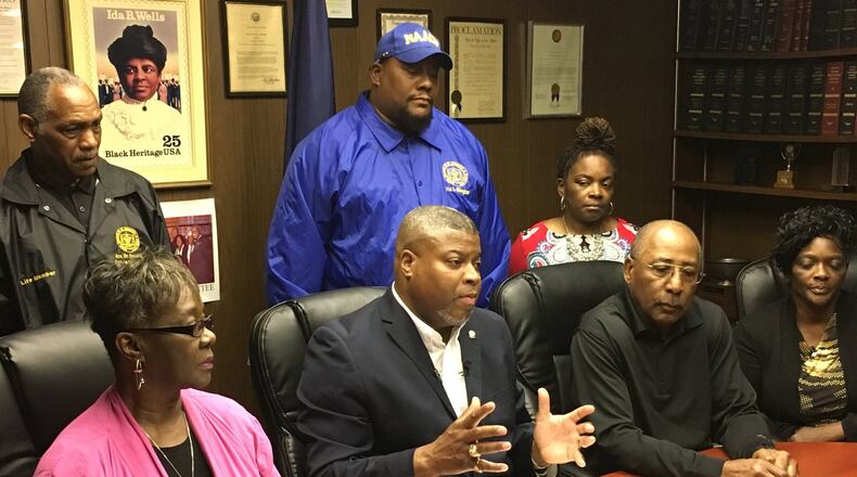 Derrick L. Foward, NAACP Dayton Unit president (center), and education chair Lauretta Williams (left) said Dunbar High School coaches and athletic directors should be punished by the OHSAA, not all athletic teams from all DPS schools. MARC PENDLETON / STAFF