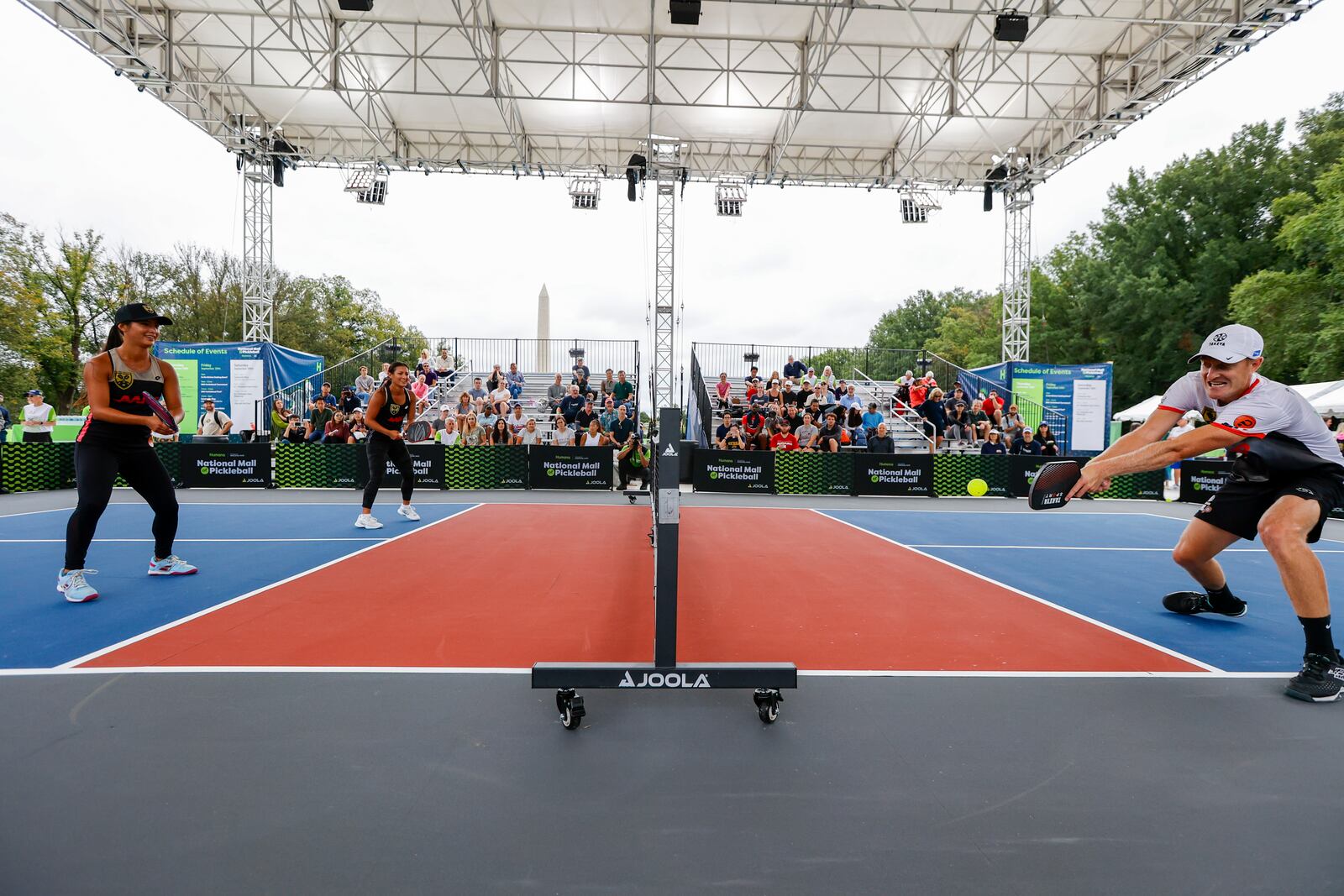 IMAGES DISTRIBUTED FOR TRUST FOR NATIONAL MALL - D.C. Pickleball Team players Jade Kawamoto, left, Jackie Kawamoto, and Riley Newman playing on center court at the National Mall of Pickleball on Saturday, Sept. 30, 2023 in Washington. (Eric Kayne/AP Images for Trust for National Mall)