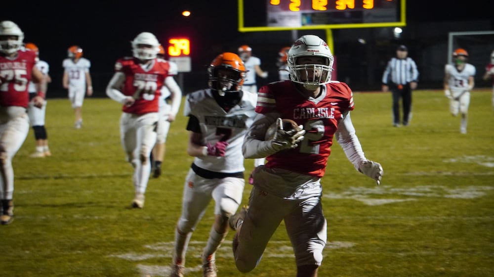 Carlisle’s Drew Conger (2) scores a touchdown against North Union in a Division V regional semifinal on Friday night at Laughlin Field. CHRIS VOGT / CONTRIBUTED
