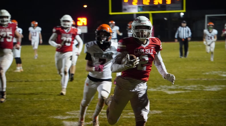 Carlisle’s Drew Conger (2) scores a touchdown against North Union in a Division V regional semifinal on Friday night at Laughlin Field. CHRIS VOGT / CONTRIBUTED