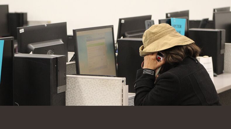 A woman works at one of the computer stations at the Job Bank. Computers are made available to the public to help citizens apply for unemployment benefits. CORNELIUS FROLIK / STAFF