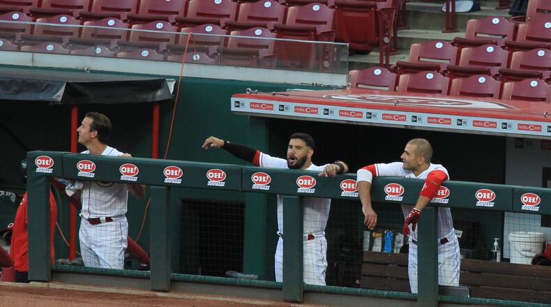 Reds players react after a home run by Mike Moustakas on Opening Day against the Tigers on Friday, July 24, 2020, at Great American Ball Park in Cincinnati.