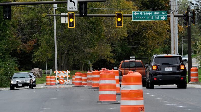 Orange barrels line Indian Ripple Road near Grange Hall Road in Beavercreek during road paving work last fall. Portions of Grange Hall are slated to be widened and repaved in 2023. MARSHALL GORBY\STAFF