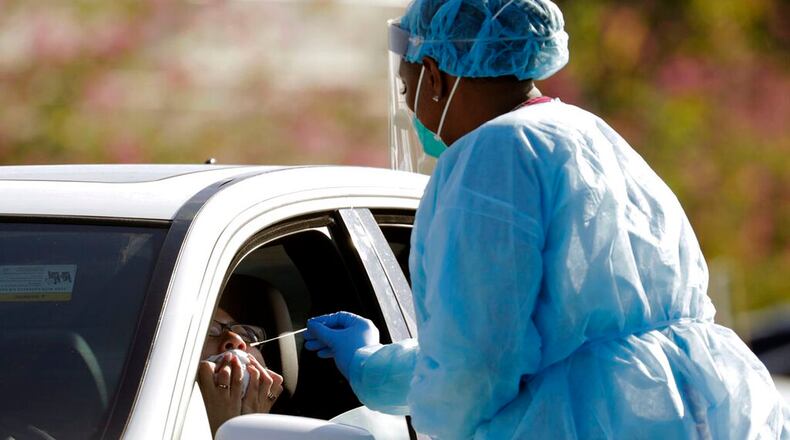 Dr. Jana Cua, left, is swabbed as she is tested for COVID-19 at the Doris Ison Health Center, Wednesday, March 18, 2020, in Miami. The testing is being provided by Community Health of South Florida, Inc. The vast majority of people recover from the new coronavirus. According to the World Health Organization, most people recover in about two to six weeks, depending on the severity of the illness. (Lynne Sladky/AP)