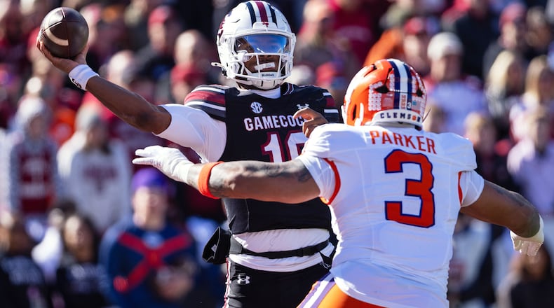 FILE - South Carolina quarterback Lanorris Sellers (16) throws under pressure from Clemson defensive end T.J. Parker (3) during the first half of an NCAA college football game, Nov. 29, 2025, in Columbia, S.C. (AP Photo/Scott Kinser, File)