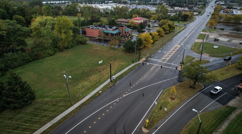 New housing can be built on land (left side of photo) near Meijer and a busy business district featuring several restaurants. The city of Kettering on Tuesday night approved a new use for a vacant site near the Wilmington Pike/Woodman Drive split. JIM NOELKER/STAFF