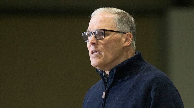 Washington State Governor Jay Inslee and other leaders speak to the press in Seattle, Washington. (Karen Ducey/Getty Images)