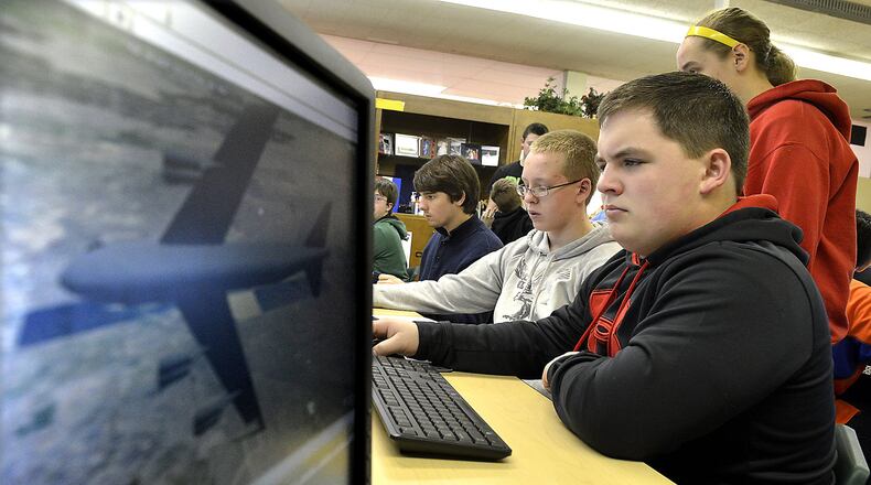 Greenon High School STEM student, Tyler Johnson, right, and his classmates work with UAS software in their class Wednesday. The STEM students are using software from Analytical Graphics Inc. to take part in a class on drones. Students will use the drone software and perform tasks like mapping out the data from a natural disaster and creating a safe evacuation plan. Bill Lackey/Staff
