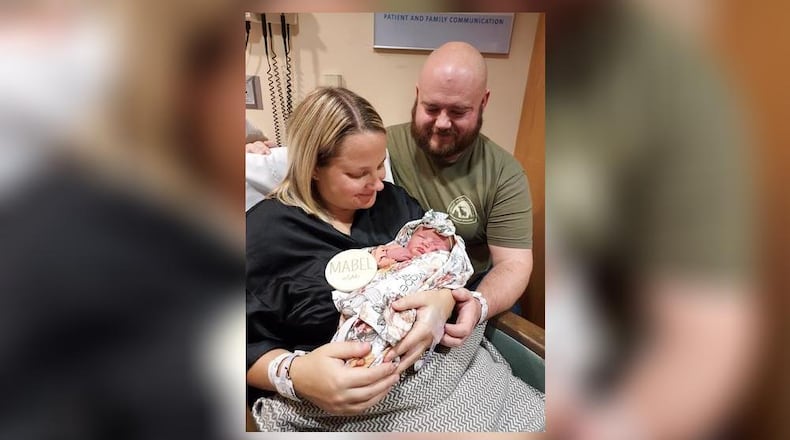 Kirstyn and Brad Stapleton hold their daughter, Mabel Mae. Mabel arrived into the new year after 2 a.m. Monday morning. CONTRIBUTED