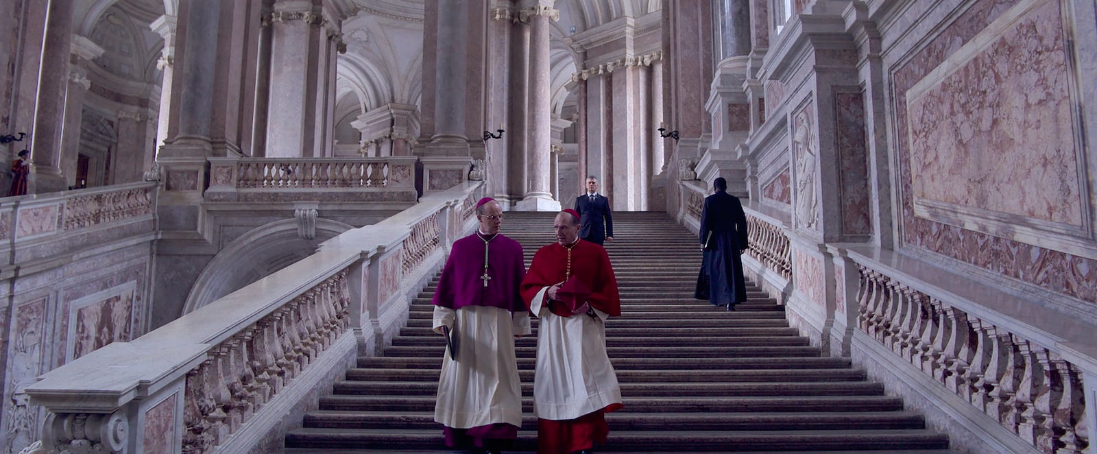This image released by Focus Features shows Brían F. O'Byrne, left, and Ralph Fiennes in a scene from "Conclave." (Focus Features via AP)