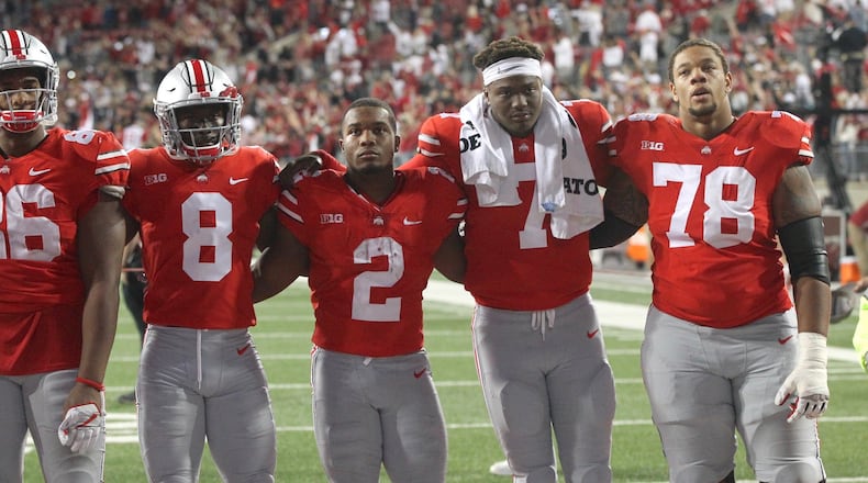 Ohio State players (left to right) Dre’Mont Jones, Kendall Sheffield, J.K. Dobbins, Dwayne Haskins and Demetrius Knox sing “Carmen Ohio” after a loss to Oklahoma on Saturday, Sept. 9, 2017, at Ohio Stadium in Columbus. David Jablonski/Staff