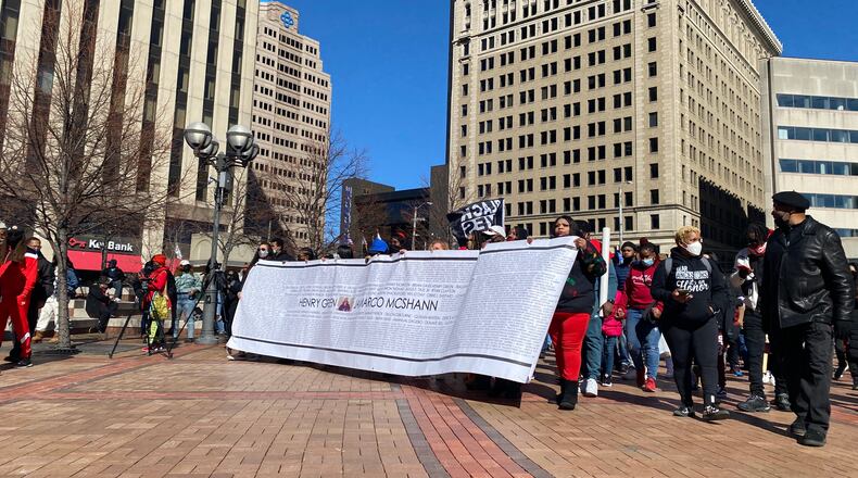Families and supporters of people killed by police violence march in Courthouse Square on Saturday, The banner is a list of names of Black people killed by police. March 3. EILEEN McCLORY STAFF