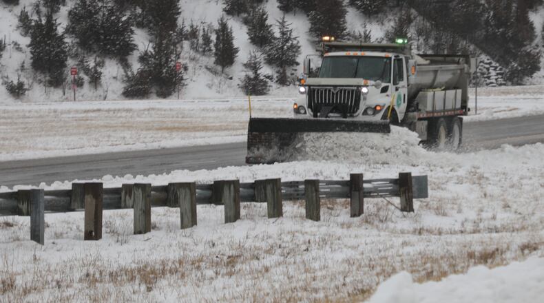 An ODOT plow truck cleans off the the left lane on Southbound Ohio Route 4 in Clark County Sunday. BILL LACKEY/STAFF