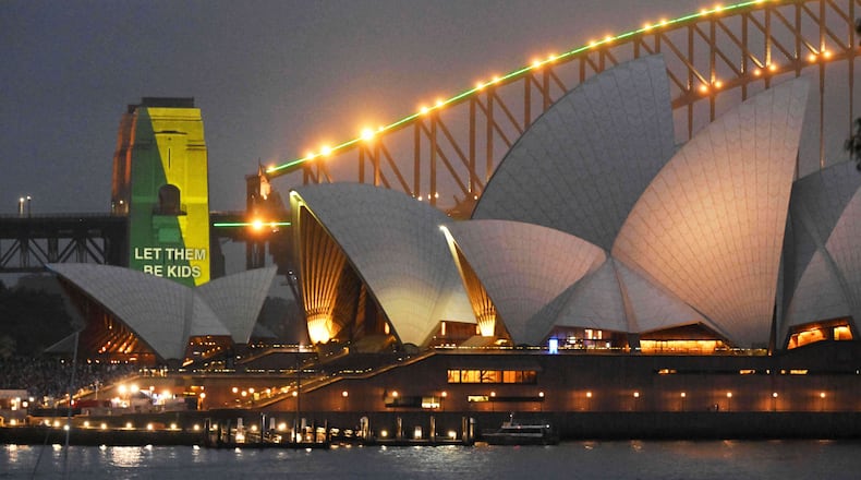 The social media ban for children under 16 slogan "Let Them Be Kids" is projected onto the pylons of the Sydney Harbour Bridge in Sydney, Wednesday, Dec. 10, 2025. (Mick Tsikas/AAP Image via AP)