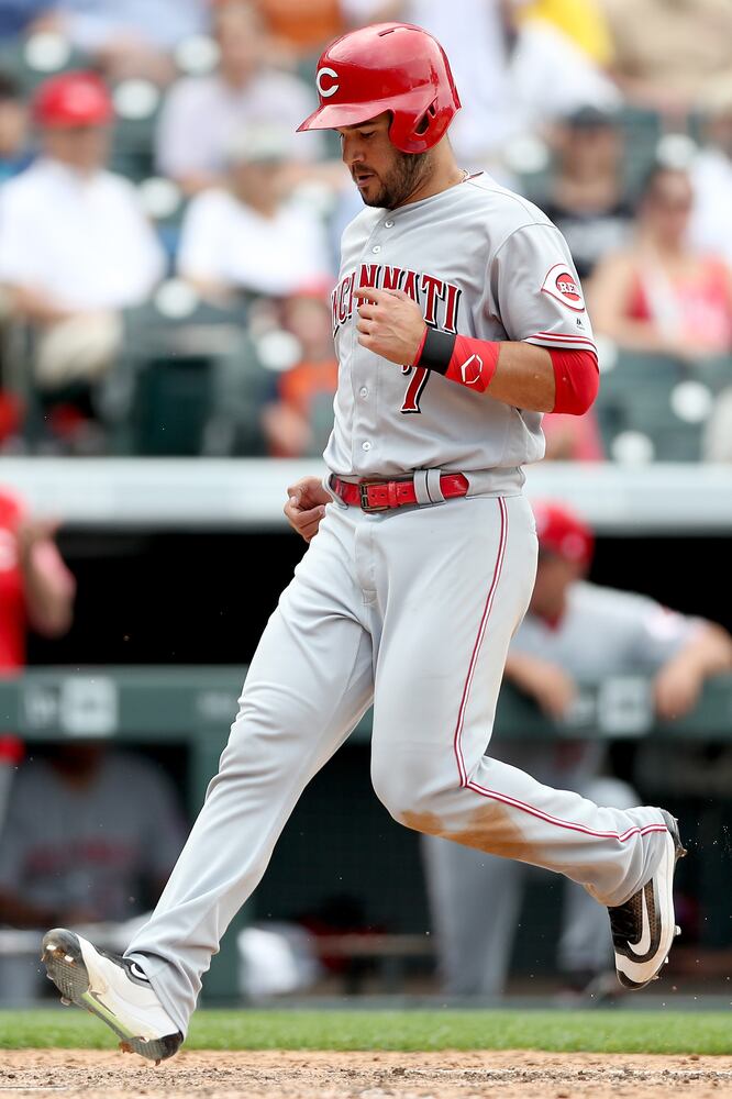 PHOTOS: Reds pile up 13 hits, beat the Rockies