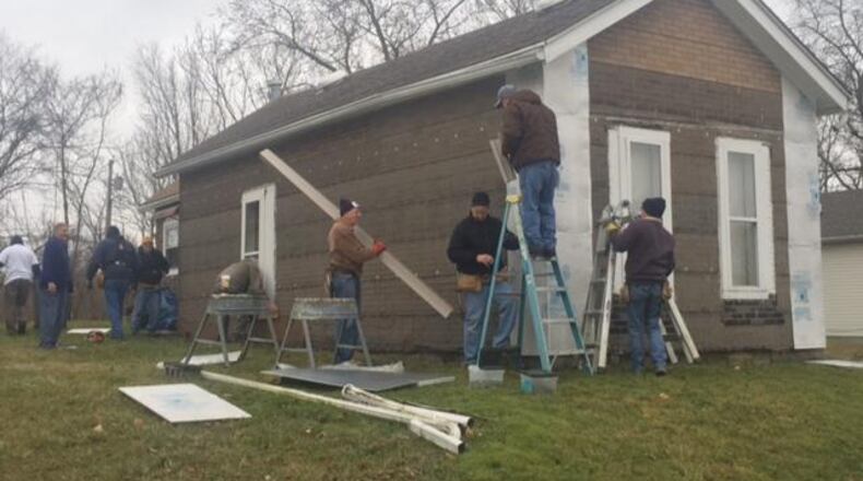 Volunteers in Xenia help fix up a woman’s home in 2017.
