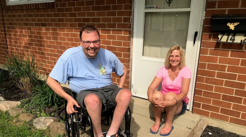 Damien Paul and his mom Gina Thomas at their Huber Heights home Friday. Tom Archdeacon/STAFF