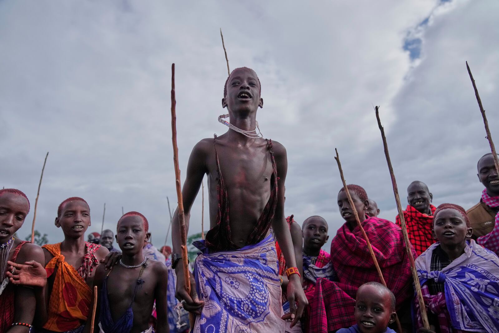Children of the Maasai tribe perform a traditional jumping dance, during the Enkipaata ceremony, a Maasai male rite of passage, specifically the initiation of boys, marking the transition from childhood to becoming a moran (warrior) in Olaimutiai, Narok County, Kenya Thursday, April 24, 2024. (AP Photo/Brian Inganga)