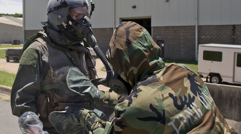 Air Force Reserve Staff Sgt. Casey Godwin, aircrew flight equipment specialist, 327th Operations Support Squadron, pats down Staff Sgt. Michael Hopson, loadmaster, 327th Airlift Squadron, with activated charcoal from an M295 Individual Decontamination Kit during a training scenario. The Air Force Civil Engineer’s Readiness Lab recently determined more than 75,000 expired M295 decontamination kits used in chemical defense ensembles are still effective and can be used, saving the Air Force more than $2.3 million over a 4-year period. (U.S. Air Force photo/Master Sgt. Jeff Walston)