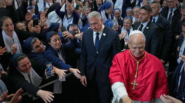 Pope Leo XIV is greeted as he arrives to meet with bishops, priests, consecrated persons and pastoral workers at the Catholic basilica of Harissa, Lebanon Monday, Dec. 1, 2025. (AP Photo/Hussein Malla)