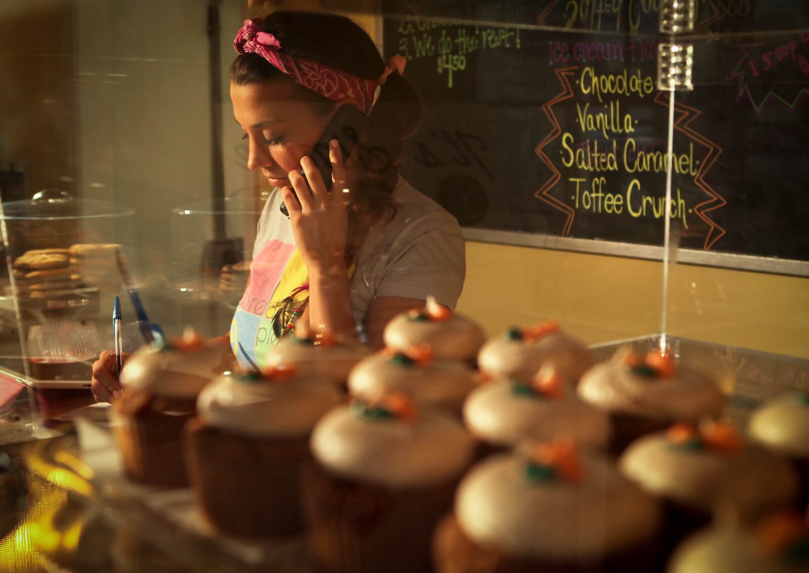 Brittany Moore takes a phone order at her business, Moore Dessert Please, a cupcake shop and bakery at 1003 Shroyer Road in Dayton. The Wall Street Journal has proclaimed that the gourmet-cupcake market is "crashing." Local gourmet-cupcake entrepreneurs beg to differ. They say southwest Ohio residents have proven they have a powerful -- and sustained -- hunger for cupcakes and other baked sweets, although some say they've expanded their offerings to keep up with the market. A UD professor says there's an inherent risk in jumping into a "trend" business, and as the market matures and becomes saturated, only those nimble enough to evolve quickly will survive in the long run.JIM WITMER / STAFF