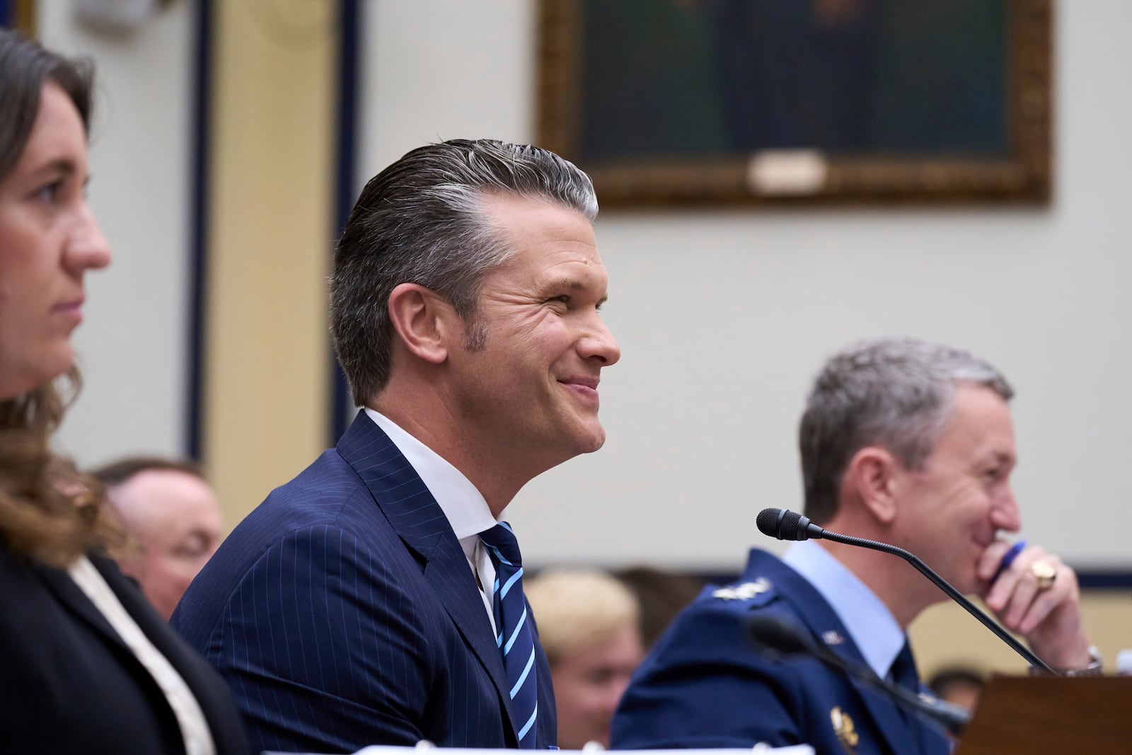 Secretary of Defense Pete Hegseth, flanked by Bryn MacDonnell, left, acting chief financial officer at the Department of Defense, and Gen. Dan Caine, chairman of the Joint Chiefs of Staff, fields questions on the Pentagon budget from the House Armed Services Committee, at the Capitol in Washington, Thursday, June 12, 2025. (AP Photo/J. Scott Applewhite)