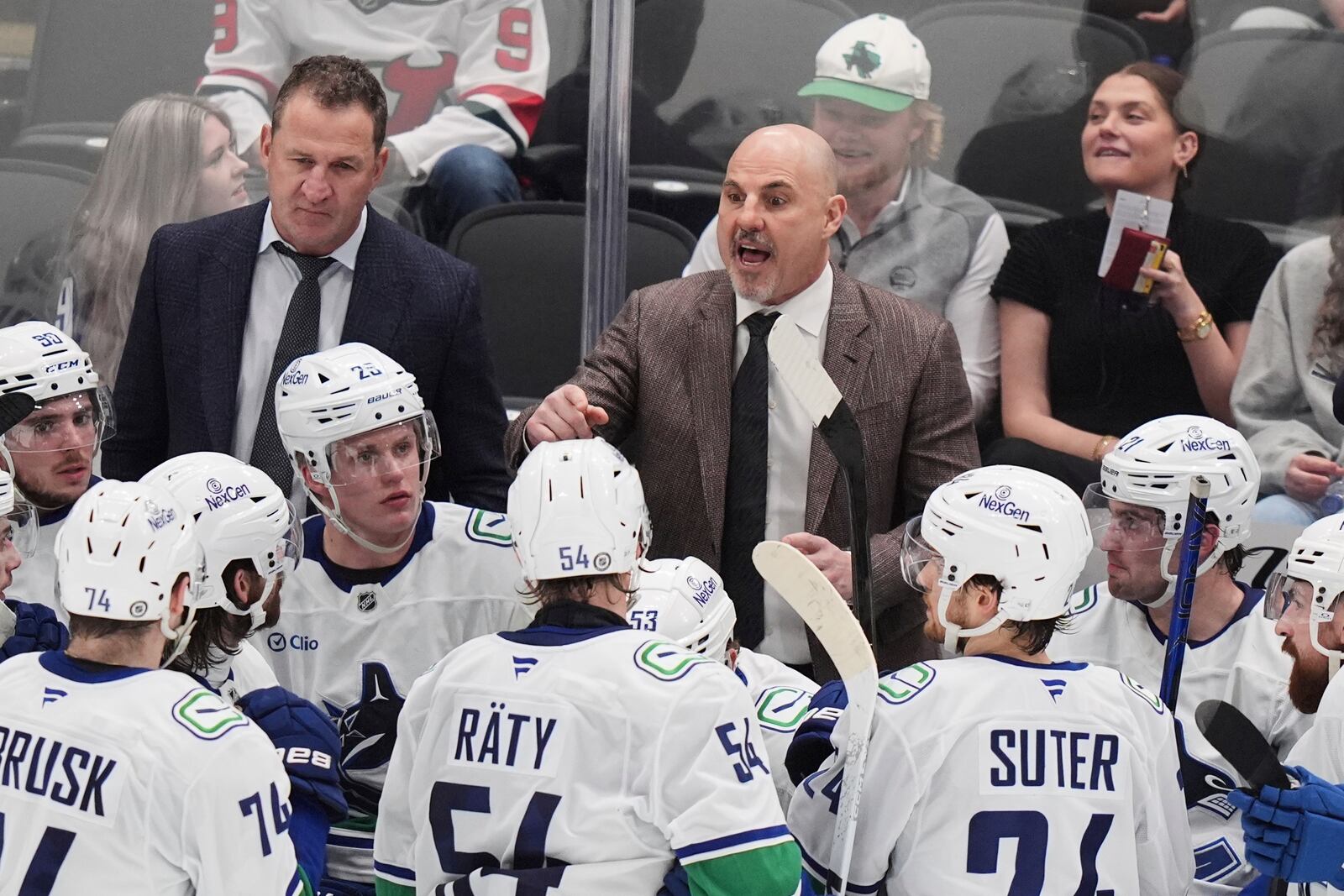 Vancouver Canucks head coach Rick Tocchet instructs his team during a time out in the third period of an NHL hockey game against the Dallas Stars in Dallas, Tuesday, April 8, 2025. (AP Photo/LM Otero)