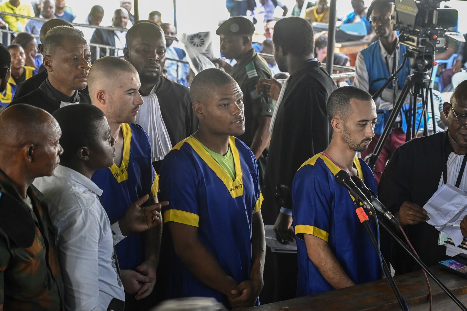 FILE - From left Tyler Thompson Jr., Marcel Malanga and Benjamin Reuben Zalman-Polun, right, all American citizens, face the court in Kinshasa with 52 other defendants on June 7, 2024, accused of a role in last month's attempted coup in Congo led by little-known opposition figure Christian Malanga in which six people were killed. (AP Photo/Samy Ntumba Shambuyi, File)
