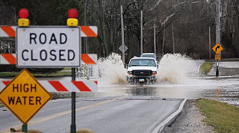 A truck drives through the high water on Lower Valley Pike Sunday. Bill Lackey/Staff