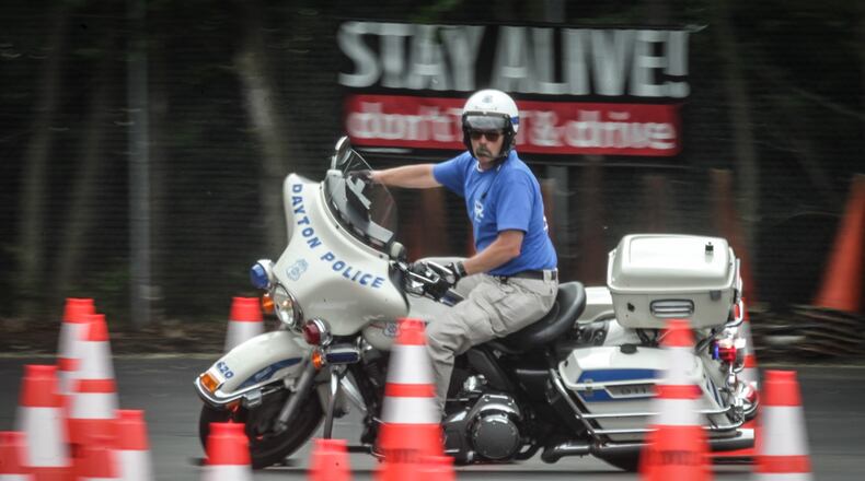 Dayton Police motor officer instructor, Jack Miniard runs through the training course in Moraine Wednesday morning. JIM NOELKER/STAFF