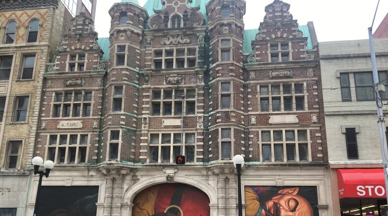 Vinyl posters depicting a sleeping giant are covering the north entrance of the Dayton Arcade. CORNELIUS FROLIK/STAFF