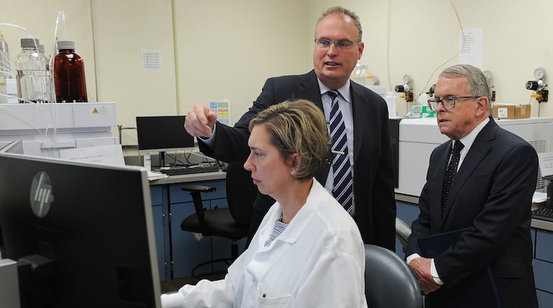 Montgomery County Coroner Dr. Kent Harshbarger, left, shows Ohio Governor Mike DeWine around the Miami Valley Regional Crime Lab, Monday May 9, 2022. The Governor visited the lab to discuss the new Ohio Crime Lab efficiency program that was developed to help eliminate-processing backlogs and increase the speed at which criminal evidence is analyzed in certified crime laboratories across the state. MARSHALL GORBY\STAFF