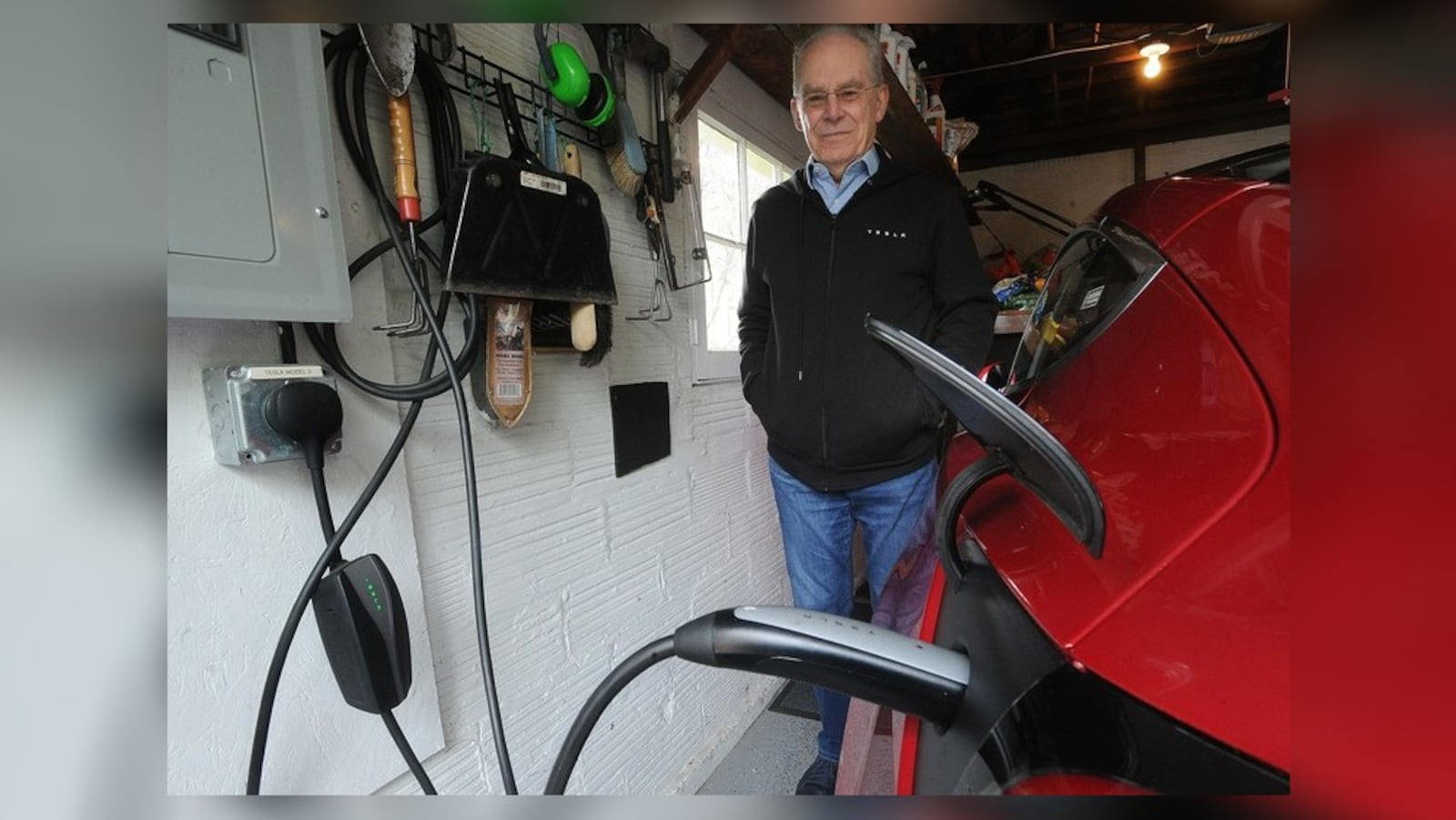 Tim Benford, founder of Drive Electric Dayton, charges his electric car at his home in Oakwood. STAFF