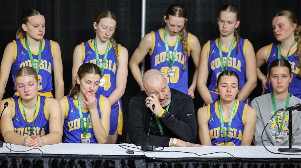 Russia coach Michael Bashore talks while players listen during a postgame news conference following a 38-17 loss to Strasburg-Franklin in the Division VII state final on Saturday, March 14 at University of Dayton Arena. BRYANT BILLING / STAFF
