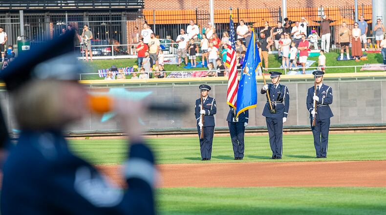 Wright-Patterson Air Force Base Honor Guard members present the colors as Master Sgt. Christin Foley, a vocalist with the Air Force Band of Flight, sings the national anthem during the Hometown Heroes event before the Dayton Dragons game Aug. 21 at Day Air Credit Union Ballpark. U.S. AIR FORCE PHOTO/WESLEY FARNSWORTH