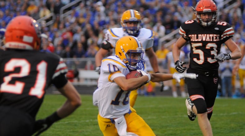 Marion Local’s Matt Rethman (with ball) is pursued by Coldwater’s Justin Schwieterman (21) and Derek Albers (53). Coldwater hosted MAC rival Marion Local in a Week 3 game on Friday, Sept. 8, 2017. MARC PENDLETON / STAFF