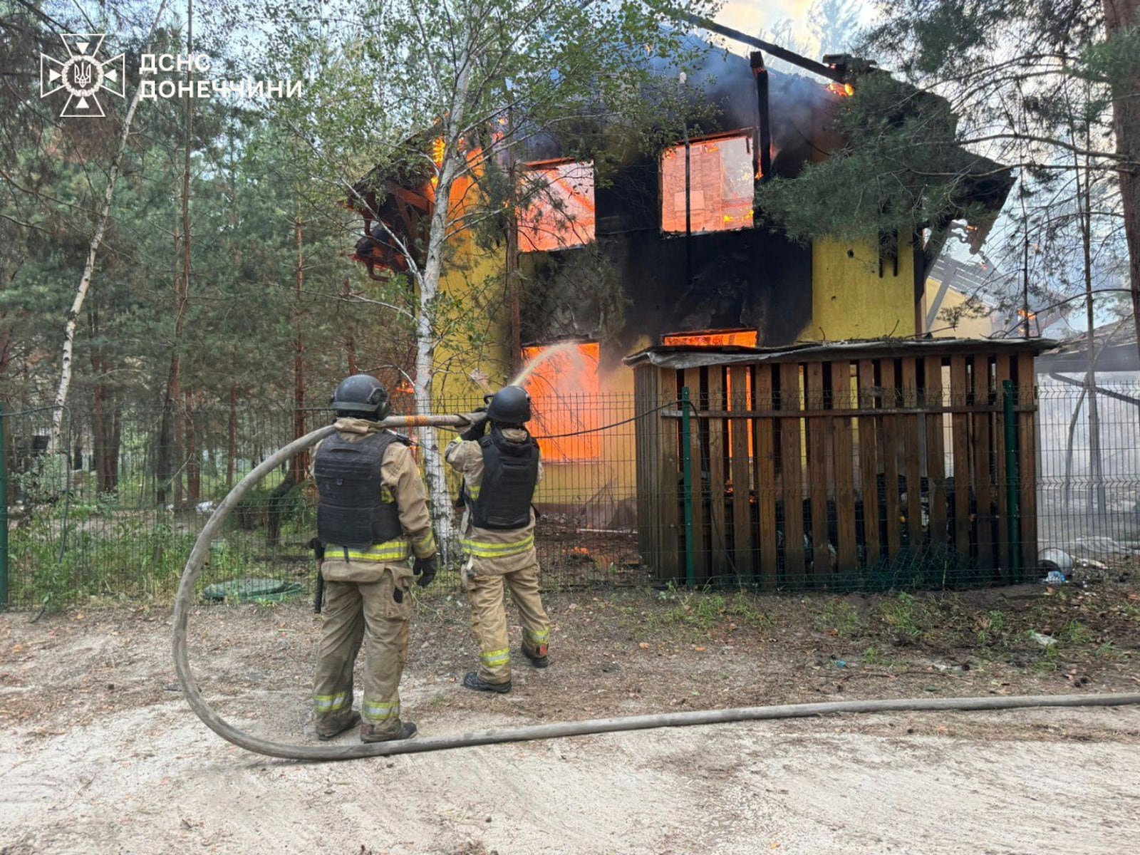 In this photo provided by the Ukrainian Emergency Service, emergency services personnel work to extinguish a fire following a Russian attack in Donetsk region, Ukraine, Wednesday, July 2, 2025. (Ukrainian Emergency Service via AP)