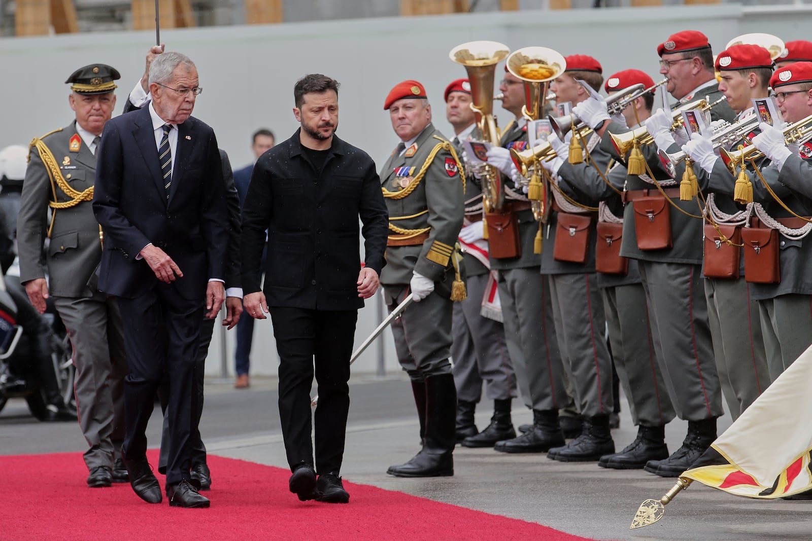 Ukraine's President Volodymyr Zelenskyy, right, and Austrian President Alexander van Der Bellen walk past the honour guard in Vienna, Austria, Monday, June 16, 2025. (AP Photo/Heinz-Peter Bader)