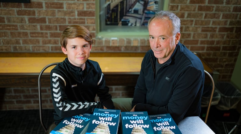 Adam Emoff, 14, is shown with his dad, Mike. The two have collaborated on a new book "The Money will Follow." Young Emoff is the author of more than 23 books. CONTRIBUTED
