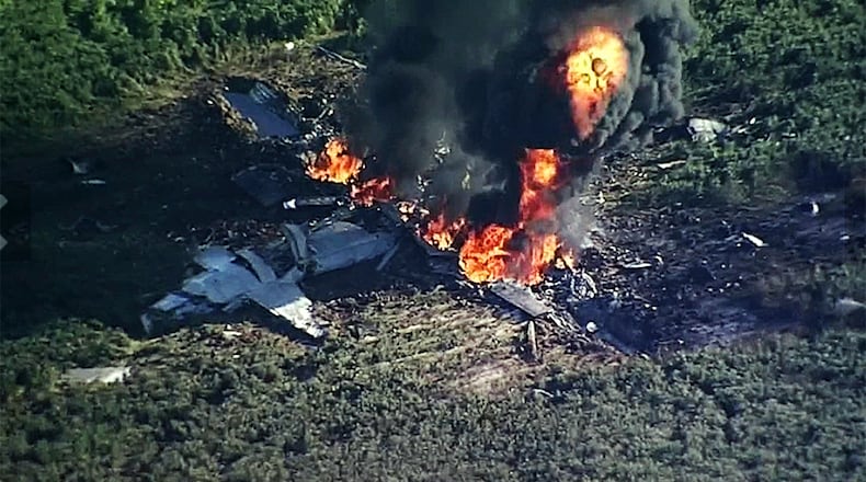 FILE - In this July 10, 2017, file image made from video provided by WLBT-TV, smoke and flames rise from a military plane that crashed in a farm field in Itta Bena, Miss. (WLBT-TV via AP, File)