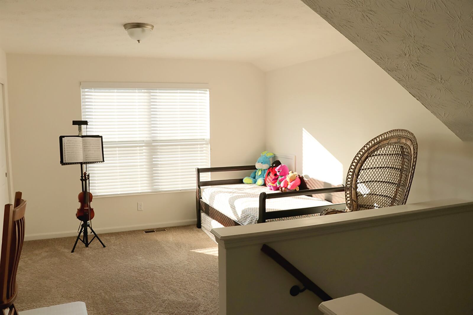 Upstairs, the staircase ends at a loft room, which is set up as an upstairs sitting room. The loft has a closet and side window and could be a play space or study. CONTRIBUTED PHOTO BY KATHY TYLER
