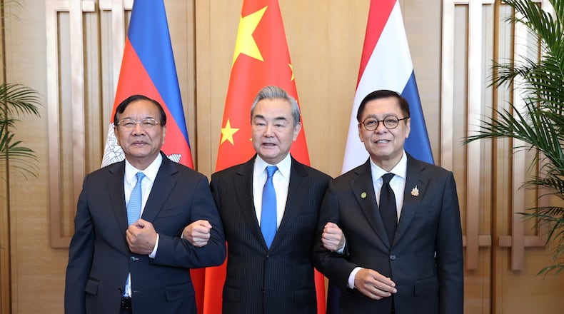 In this photo released by Agence Kampuchea Press (AKP), Cambodia's Foreign Minister Prak Sokhonn, left, Thai counterpart Sihasak Phuangketkeow, right, and Chinese counterpart Wang Yi pose for a photograph in Yunnan province, China, Monday, Dec. 29, 2025. (AKP via AP)