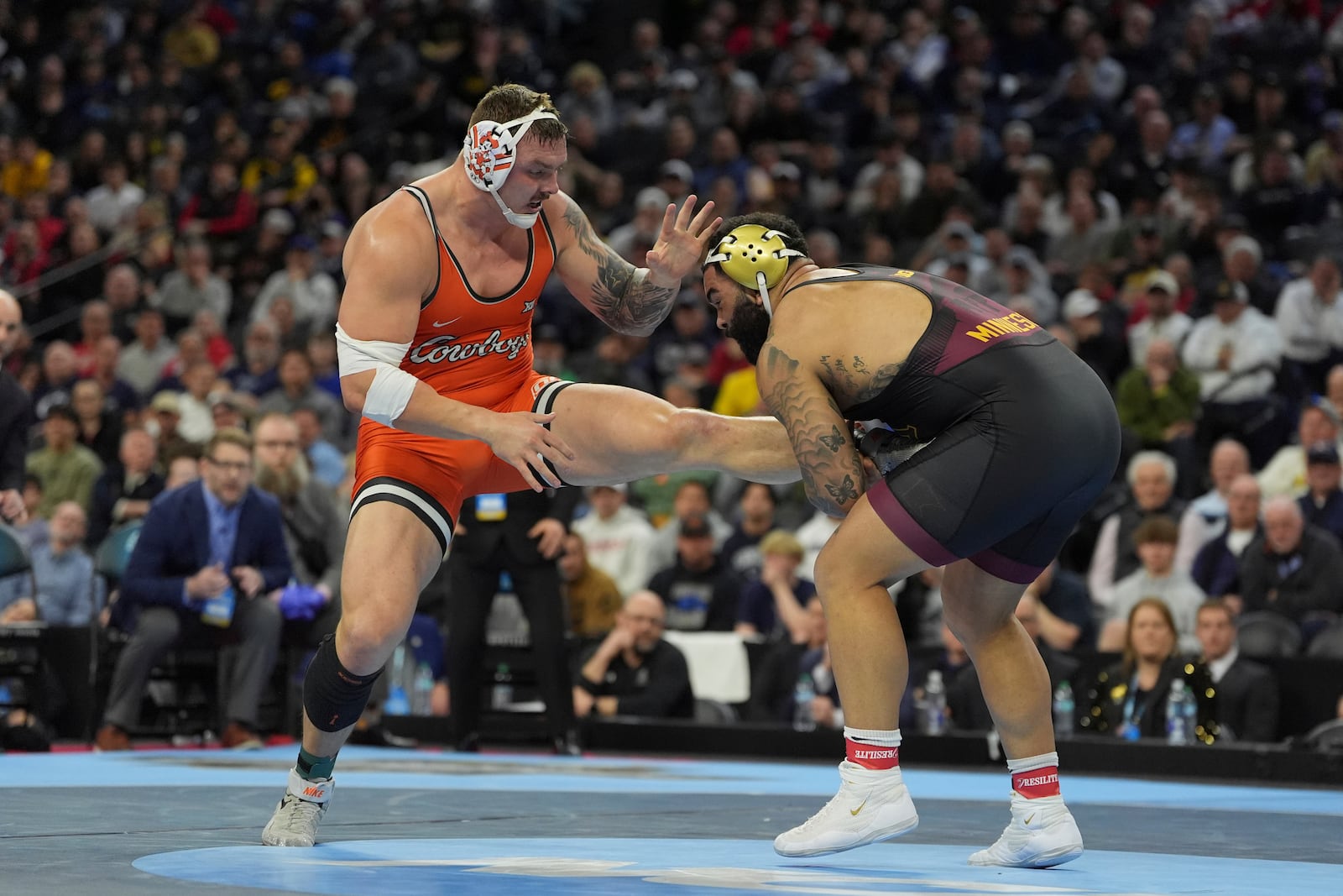 FILE - Oklahoma State's Wyatt Hendrickson, left, takes on Minnesota's Gable Steveson during a 285-pound match in the finals at the NCAA wrestling championship, Saturday, March 22, 2025, in Philadelphia. (AP Photo/Matt Rourke, File)