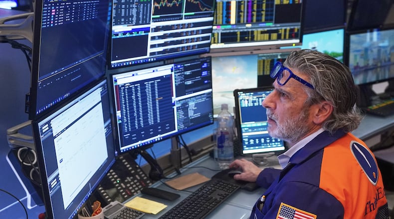 Trader John Romolo works on the floor of the New York Stock Exchange, Friday, Feb. 20, 2026. (AP Photo/Richard Drew)