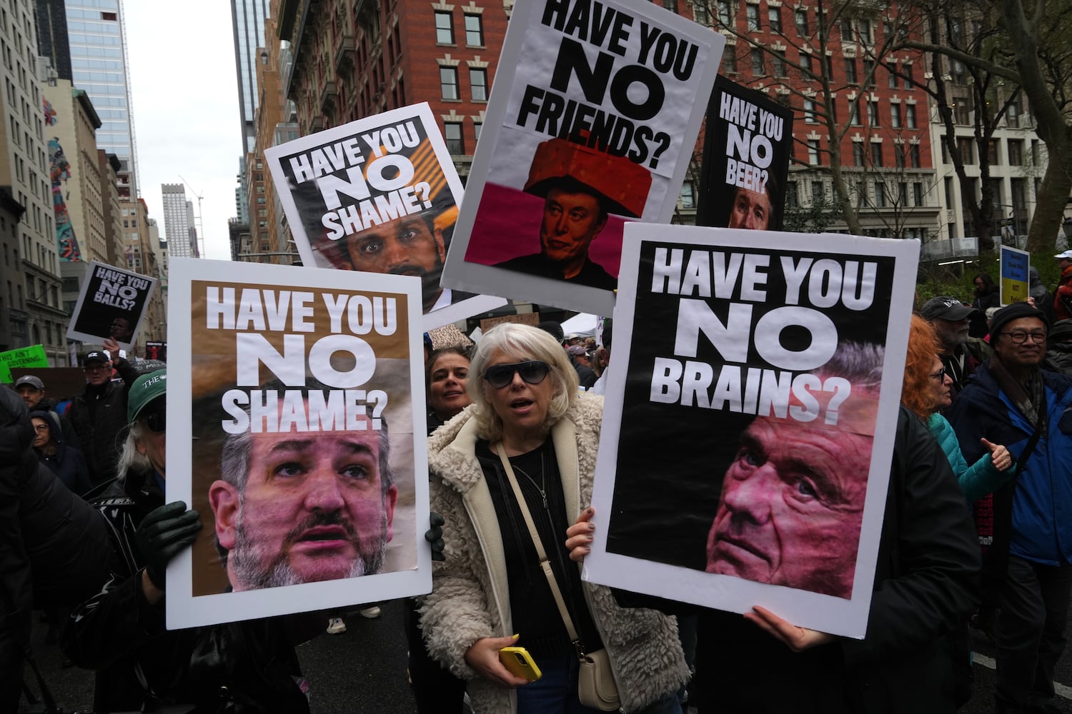 Demonstrators march through the streets in Manhattan during a Hands Off protest against President Donald Trump and Elon Musk on Saturday, April 5, 2025. (Adam Gray/The New York Times)