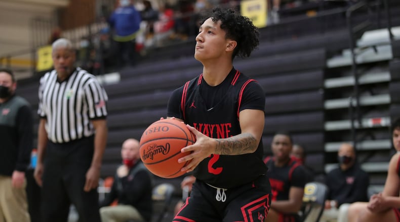 Cutline2: Wayne High School's Ray Greene shoots a 3-pointer during their game on Friday night at Centerville High School. Wayne won 66-48. Michael Cooper/CONTRIBUTED