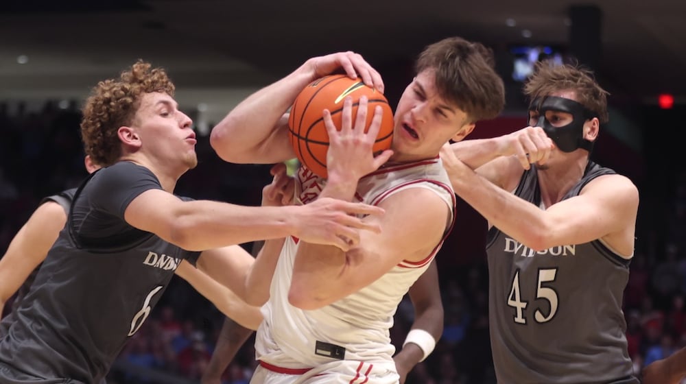 Dayton's Jordan Derkack tries to hold onto the ball against Davidson on Sunday, Feb. 15, 2026, at UD Arena. David Jablonski/Staff